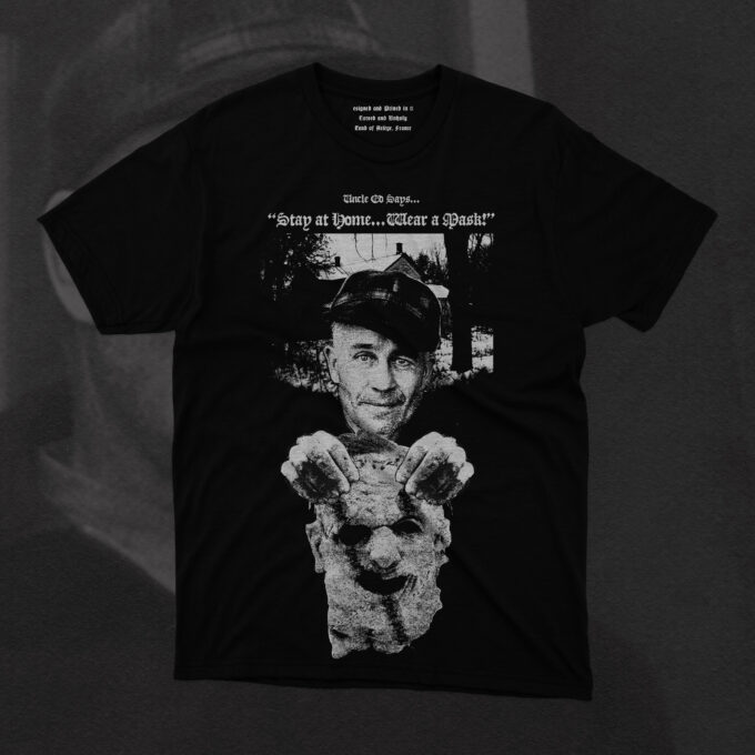 The design features Gein holding a mask made of human skin